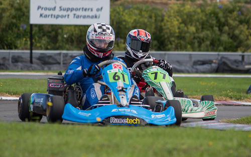 125cc Rotax Max Heavy Masters division winner Brent Melhop (#61) leads Brent Jeffares (#77 )