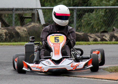 Corey Green rides the kerb on the way to victory in 125cc Rotax Max Light