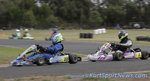Brayden Flood (#23) fending off Jimmy Mason (#74) for the lead in heat 1  in TAG Restricted Light