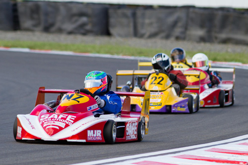 Wellington's Karl Wilson (#NZ) leading Paul Dunlop on his way to winning the 2014 New Zealand SuperKart Grand Prix at Taupo