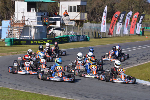 The Sodi Junior Rotax Trophy Class racing into turn one 