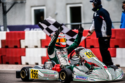 Armstrong greets the chequered flag in the KF class final 