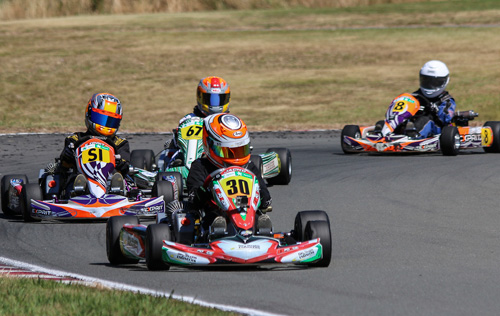 Vortex Mini ROKers Jackson Rooney (#30), William Exton (#SI) and Thomas Boniface (#67) battle for position at a previous event