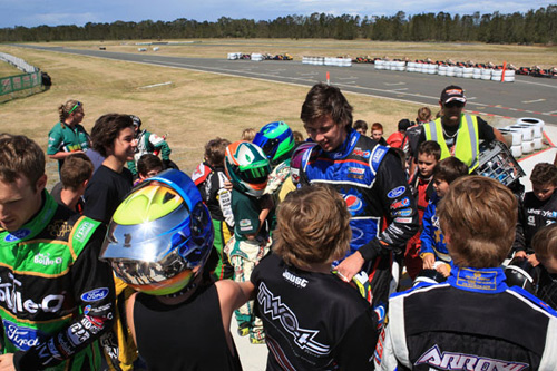 Bathurst 1000 Champion Chaz Mostert speaking to some of the junior racers trackside 