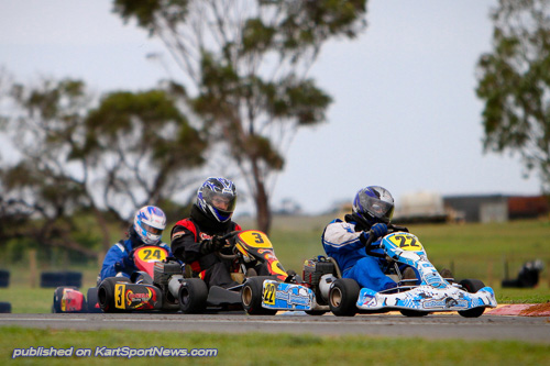 David Parkinson #22 leads Craig Henderson #3 and Troy Lymn #24 thru the infield in Clubman Over 40s